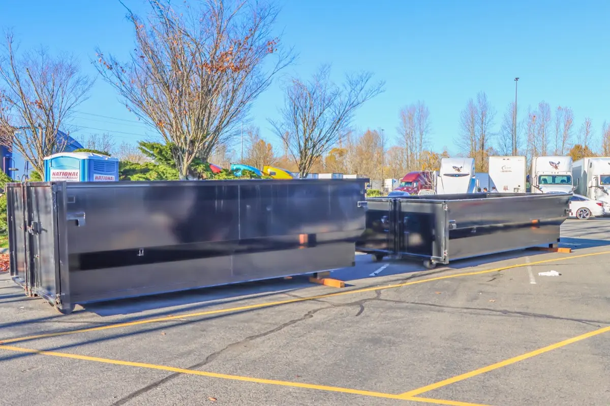 Professional dumpster rental service with roll-off container on residential driveway in Sudden Valley
